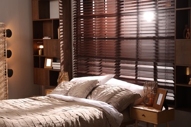 Photo of Comfortable bed with beautiful linens in bedroom