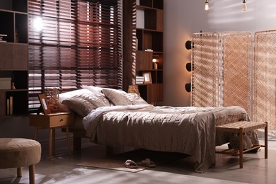 Photo of Comfortable bed with beautiful linens in bedroom