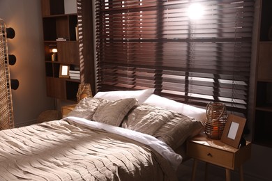 Photo of Comfortable bed with beautiful linens in bedroom