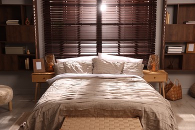 Photo of Comfortable bed with beautiful linens in bedroom