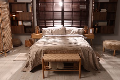 Photo of Comfortable bed with beautiful linens in bedroom