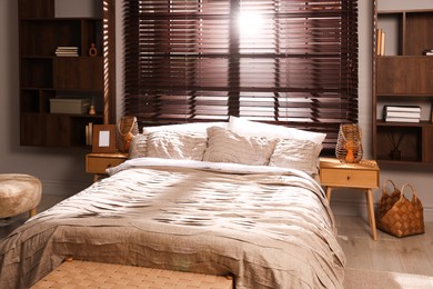 Photo of Comfortable bed with beautiful linens in bedroom