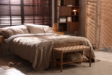 Photo of Comfortable bed with beautiful linens in bedroom