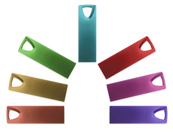 Image of Colorful flash drives isolated on white, collage. Top view