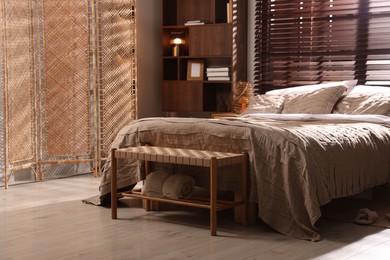 Photo of Comfortable bed with beautiful linens in bedroom