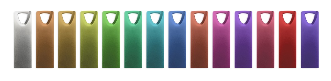 Image of Colorful flash drives isolated on white, collage. Top view
