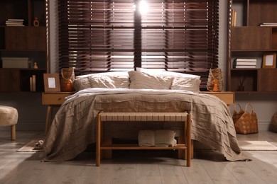 Photo of Comfortable bed with beautiful linens in bedroom