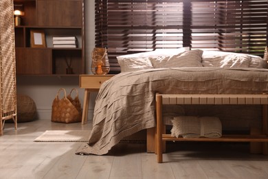 Photo of Comfortable bed with beautiful linens in bedroom