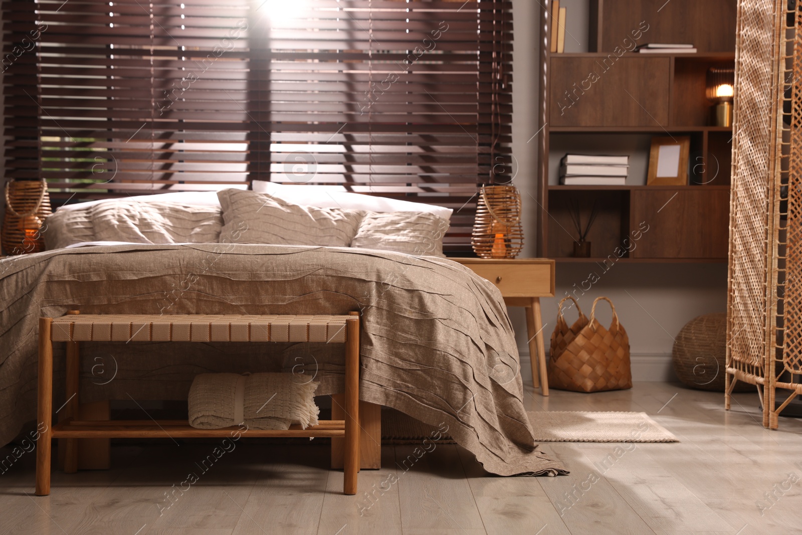 Comfortable bed with beautiful linens in bedroom Photo of Comfortable bed with beautiful linens in bedroom