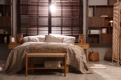 Photo of Comfortable bed with beautiful linens in bedroom