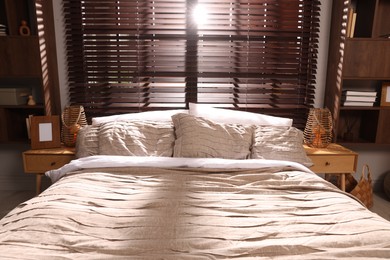 Photo of Comfortable bed with beautiful linens in bedroom