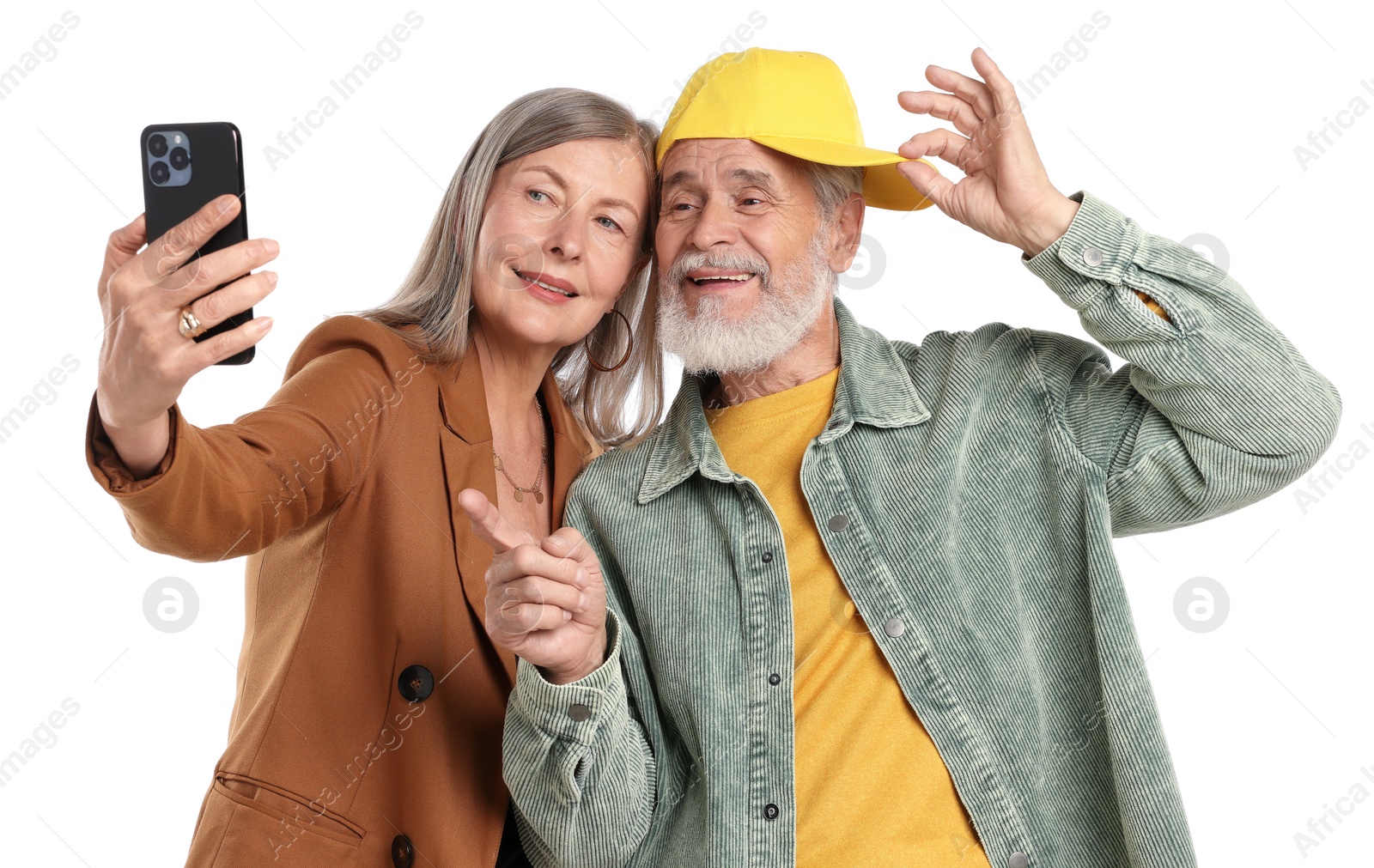 Senior couple in stylish outfits taking selfie on white background Photo of Senior couple in stylish outfits taking selfie on white background