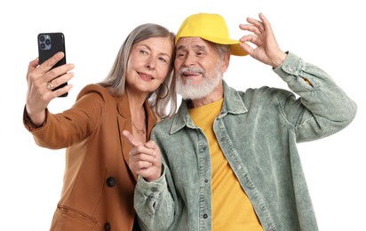 Photo of Senior couple in stylish outfits taking selfie on white background