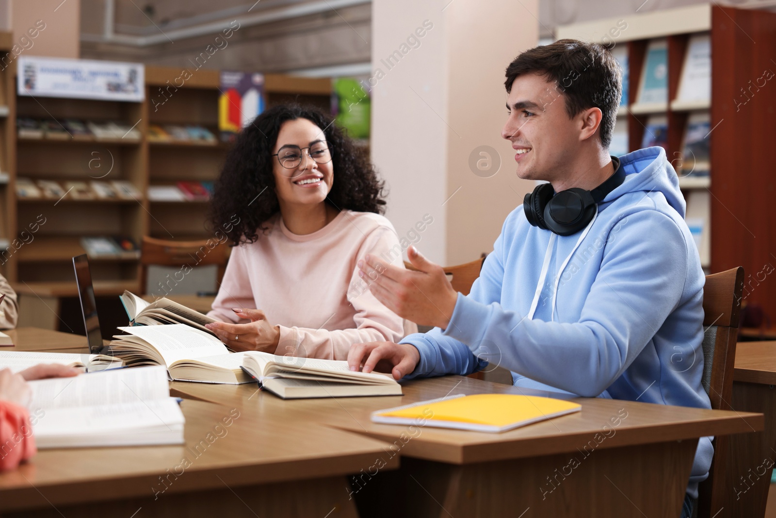People studying together at desks in public library Photo of People studying together at desks in public library