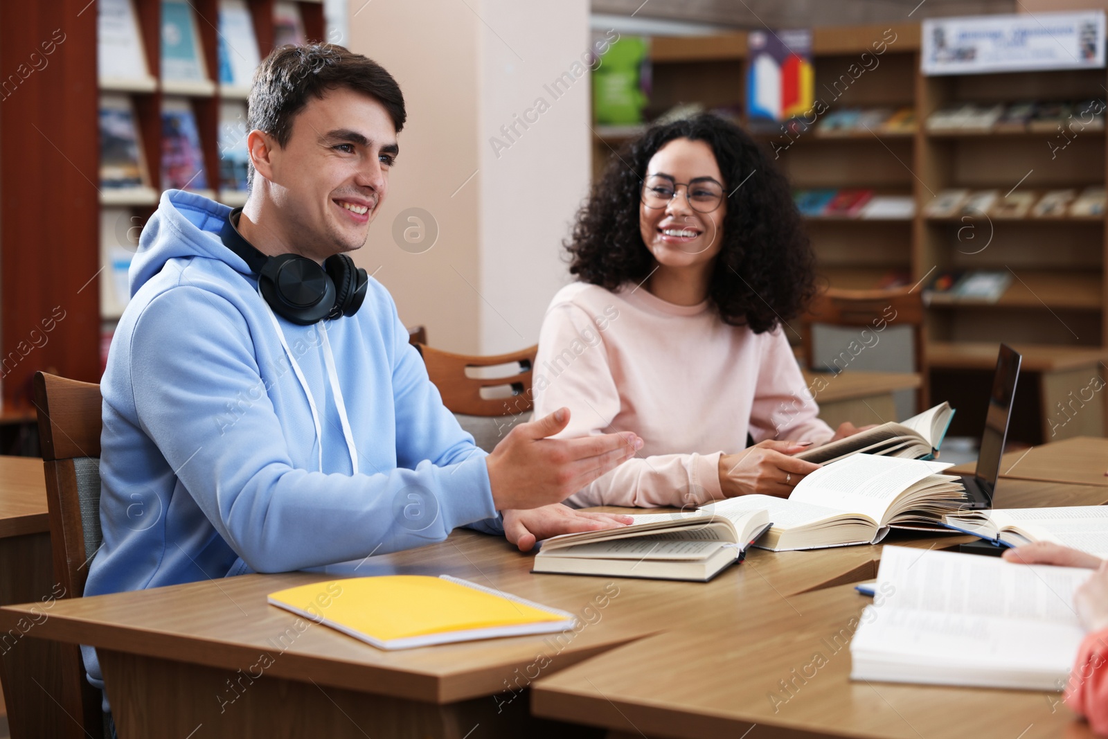 People studying together at desks in public library Photo of People studying together at desks in public library