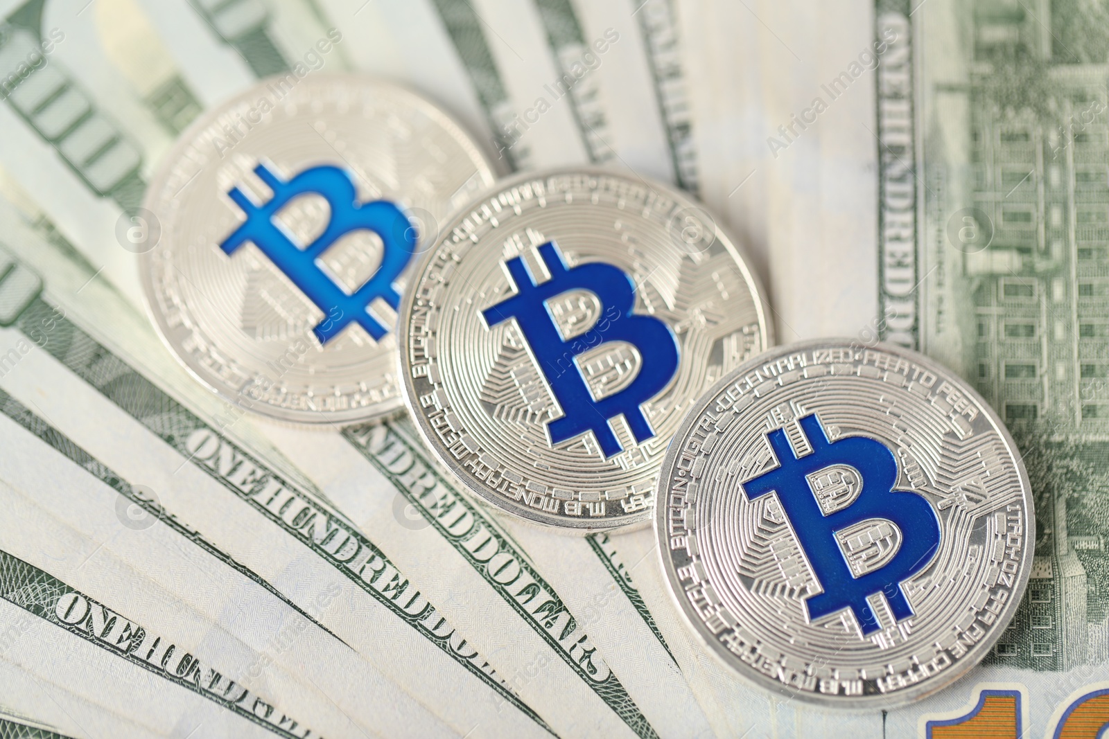 Cryptocurrency. Bitcoins on dollar banknotes, above view Photo of Cryptocurrency. Bitcoins on dollar banknotes, above view