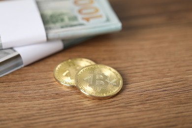 Photo of Cryptocurrency. Bitcoins and dollar banknotes on wooden table, closeup