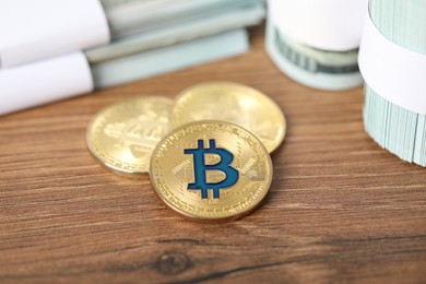 Photo of Cryptocurrency. Bitcoins and dollar banknotes on wooden table, closeup