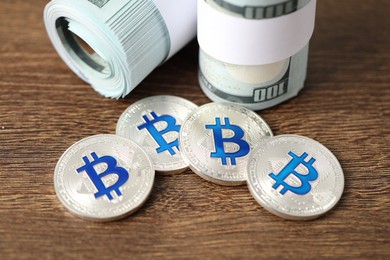 Photo of Cryptocurrency. Bitcoins and dollar banknotes on wooden table, closeup