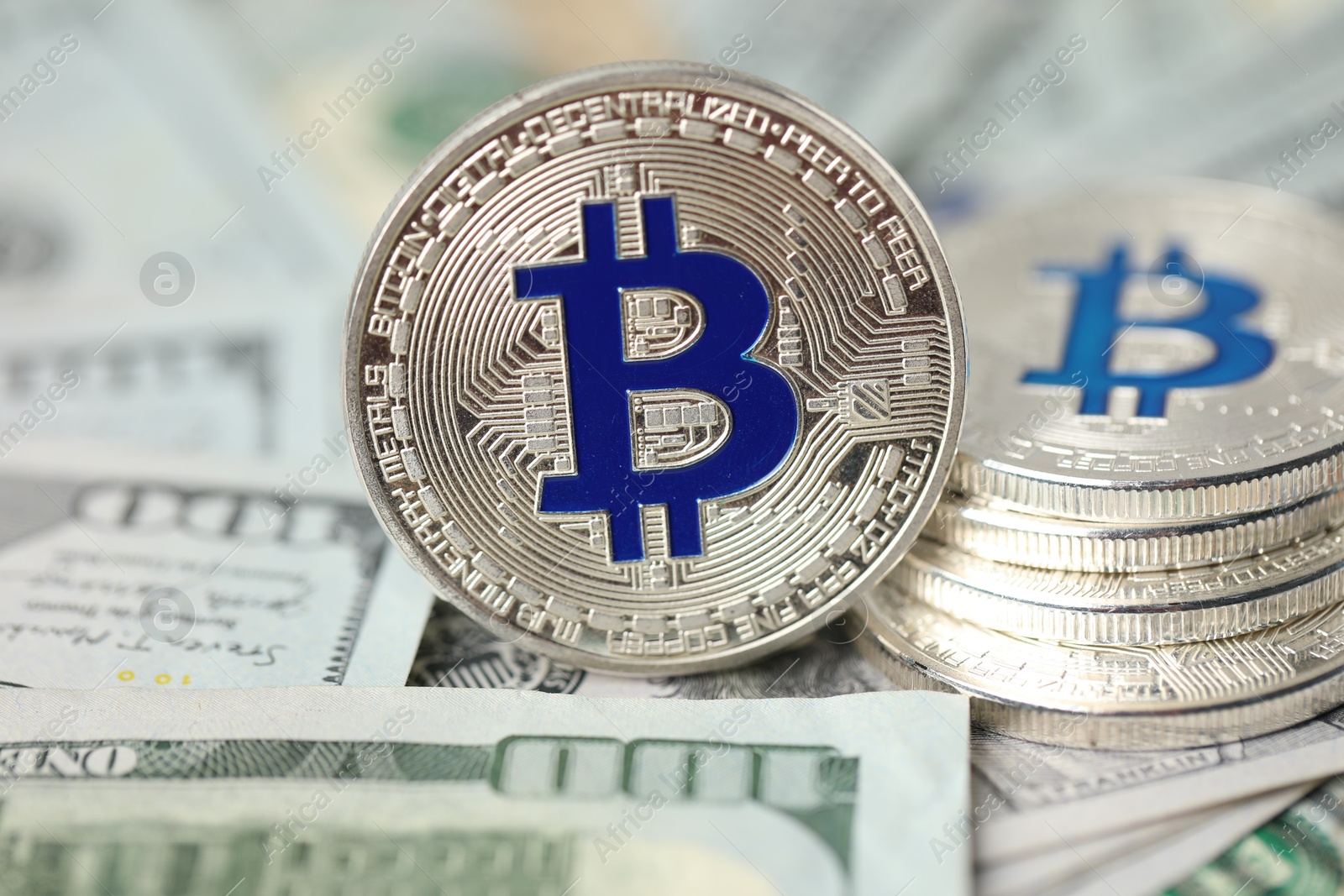 Cryptocurrency. Many bitcoins on dollar banknotes, closeup Photo of Cryptocurrency. Many bitcoins on dollar banknotes, closeup