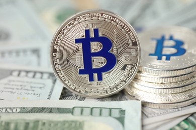 Photo of Cryptocurrency. Many bitcoins on dollar banknotes, closeup