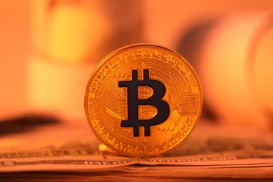 Photo of Cryptocurrency. Bitcoin and dollar banknote on table, closeup