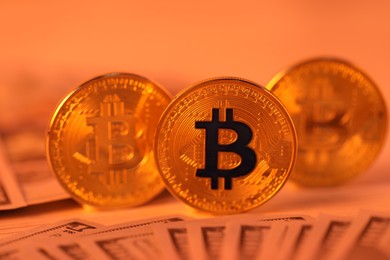 Photo of Cryptocurrency. Bitcoins and dollar banknotes on table, closeup