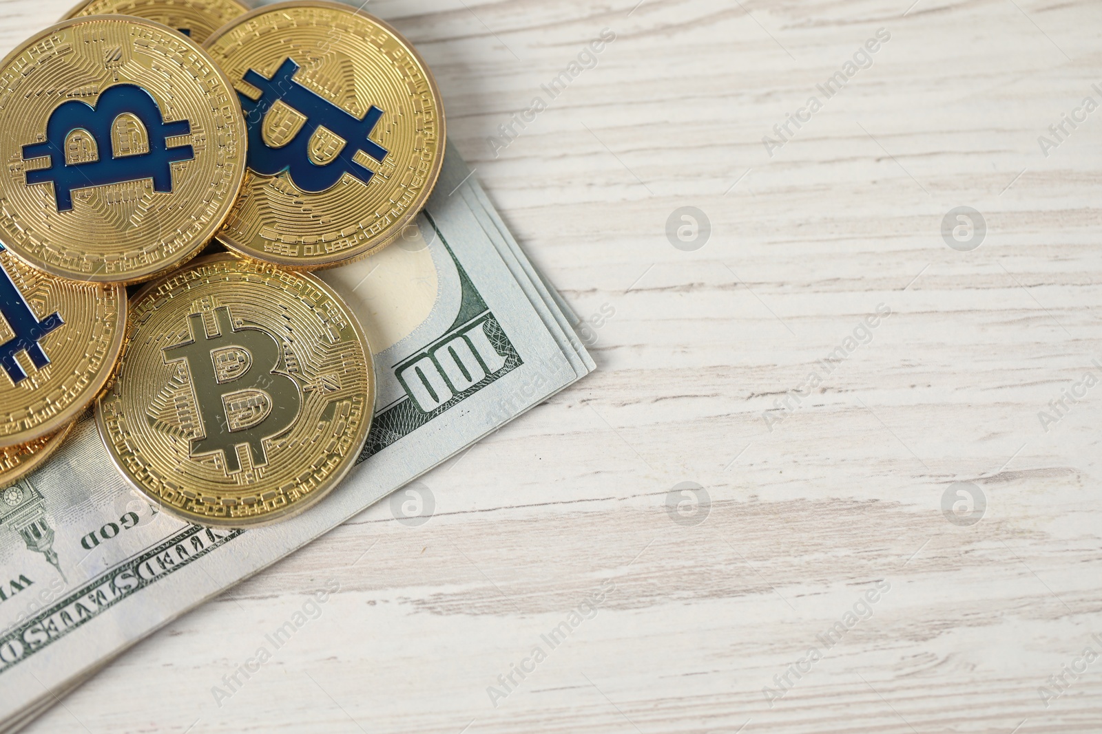 Cryptocurrency. Bitcoins and dollar banknotes on wooden table, top view. Space for text Photo of Cryptocurrency. Bitcoins and dollar banknotes on wooden table, top view. Space for text