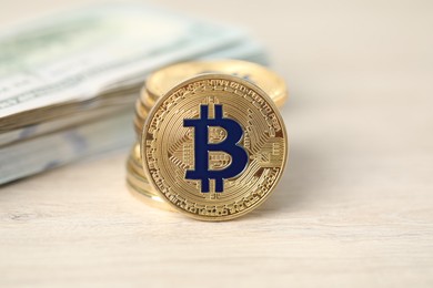 Photo of Cryptocurrency. Bitcoins and dollar banknotes on wooden table, closeup