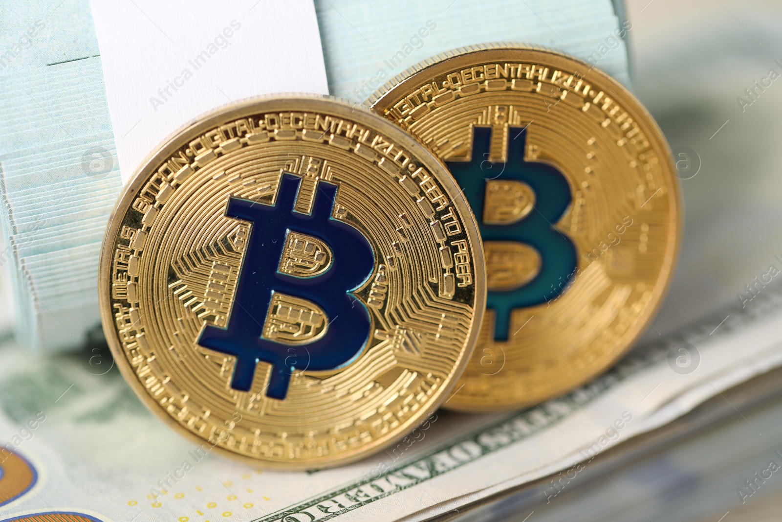 Photo of Cryptocurrency. Bitcoins on dollar banknotes, closeup view