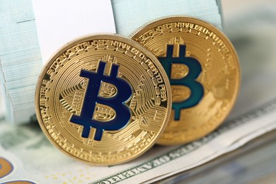 Photo of Cryptocurrency. Bitcoins on dollar banknotes, closeup view