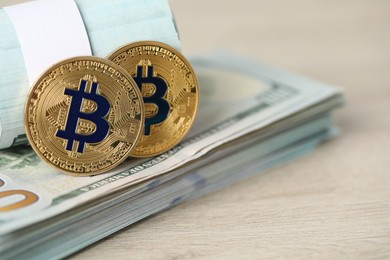 Photo of Cryptocurrency. Bitcoins and dollar banknotes on wooden table, closeup. Space for text