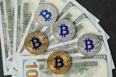 Photo of Cryptocurrency. Bitcoins and dollar banknotes on black table, flat lay
