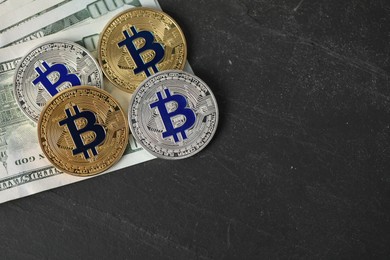 Photo of Cryptocurrency. Bitcoins and dollars on black table, flat lay. Space for text