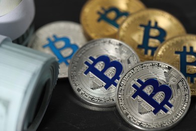 Photo of Cryptocurrency. Bitcoins and dollar banknotes on black table, closeup