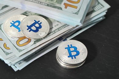 Photo of Cryptocurrency. Bitcoins and dollar banknotes on black table, closeup