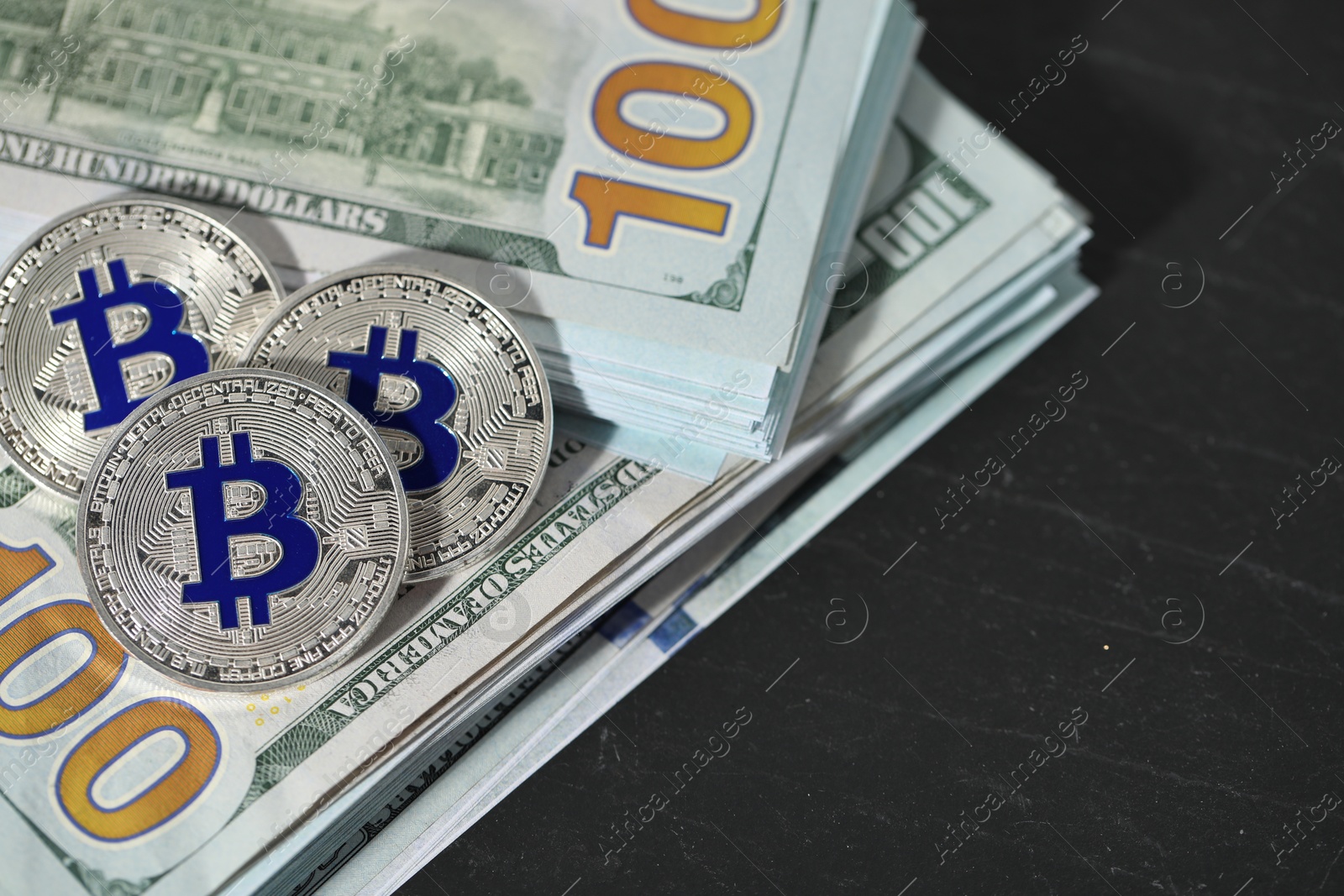 Cryptocurrency. Bitcoins and dollar banknotes on black table, above view. Space for text Photo of Cryptocurrency. Bitcoins and dollar banknotes on black table, above view. Space for text