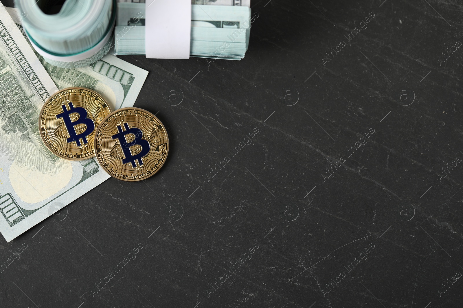 Photo of Cryptocurrency. Bitcoins and dollars on black table, flat lay. Space for text