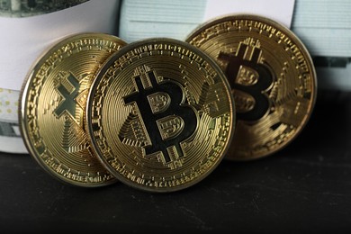 Photo of Cryptocurrency. Bitcoins and dollar banknotes on black table, closeup
