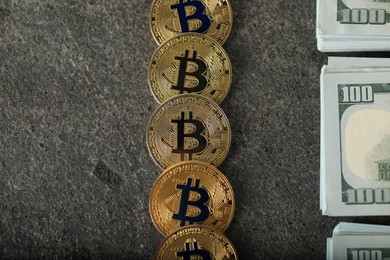 Photo of Cryptocurrency. Bitcoins and dollar banknotes on grey table, flat lay