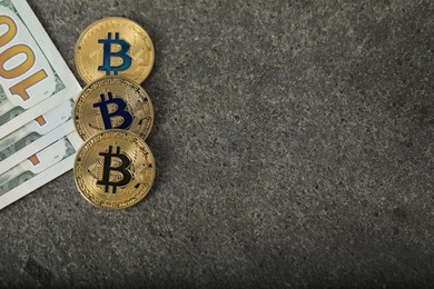Photo of Cryptocurrency. Bitcoins and dollars on grey table, flat lay. Space for text