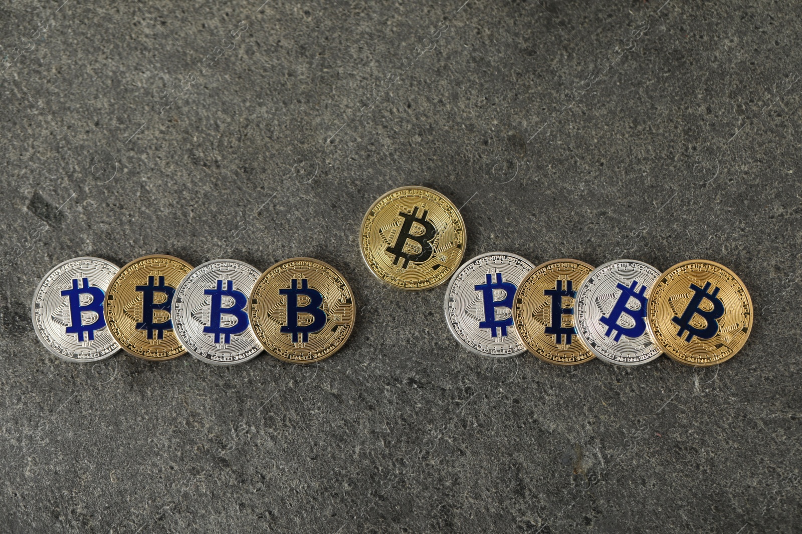 Cryptocurrency. Bitcoins on grey table, flat lay Photo of Cryptocurrency. Bitcoins on grey table, flat lay