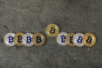 Photo of Cryptocurrency. Bitcoins on grey table, flat lay