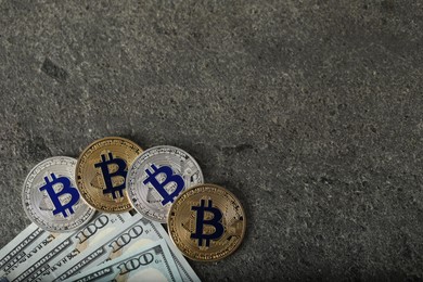 Photo of Cryptocurrency. Bitcoins and dollars on grey table, flat lay. Space for text