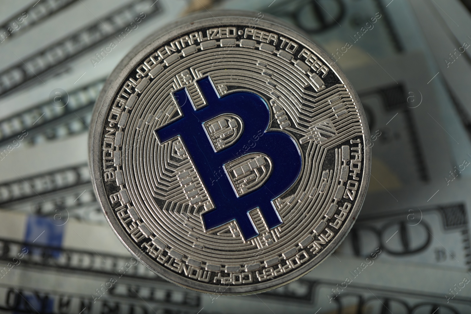 Photo of Cryptocurrency. Many bitcoins on dollar banknotes, top view