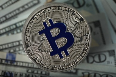 Photo of Cryptocurrency. Many bitcoins on dollar banknotes, top view