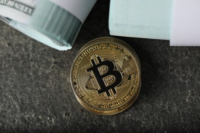 Photo of Cryptocurrency. Bitcoins and dollar banknotes on grey table, flat lay