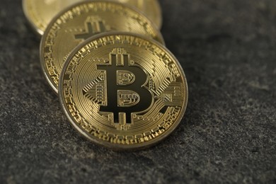 Photo of Cryptocurrency. Bitcoins on grey table, closeup view