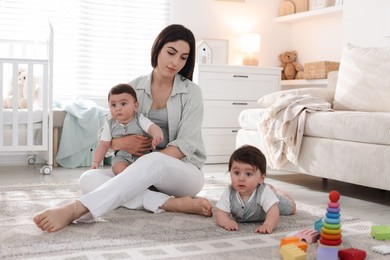 Photo of Woman suffering from postpartum depression with her little children at home
