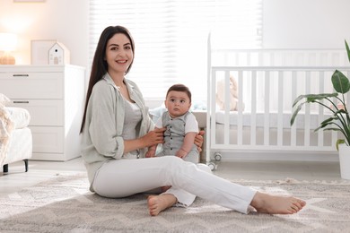 Photo of Mother with her cute baby at home. Space for text